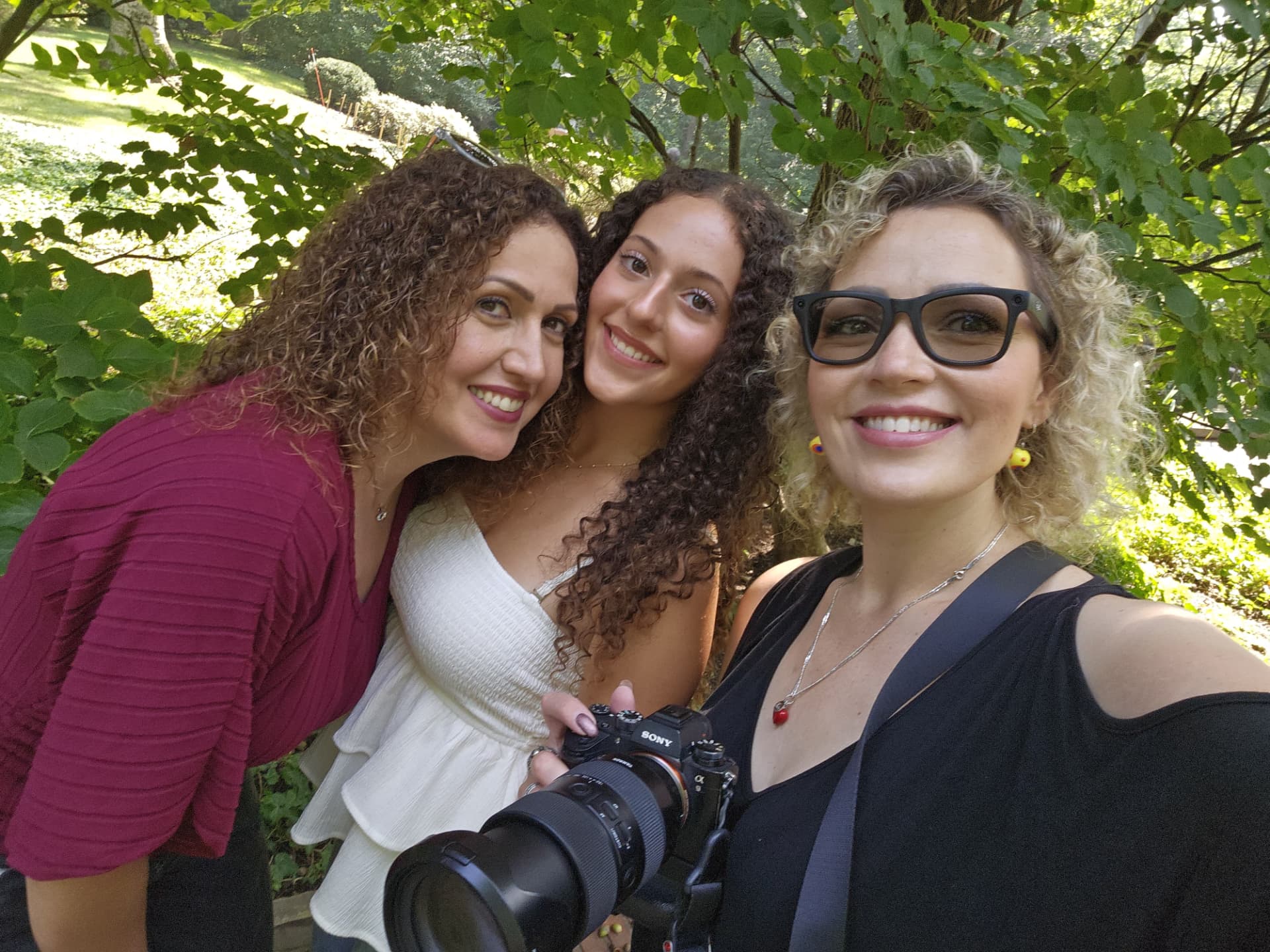 Behind the scenes photograph of Rada Abib with Naya and her family during the Cleveland Cultural Gardens senior session
